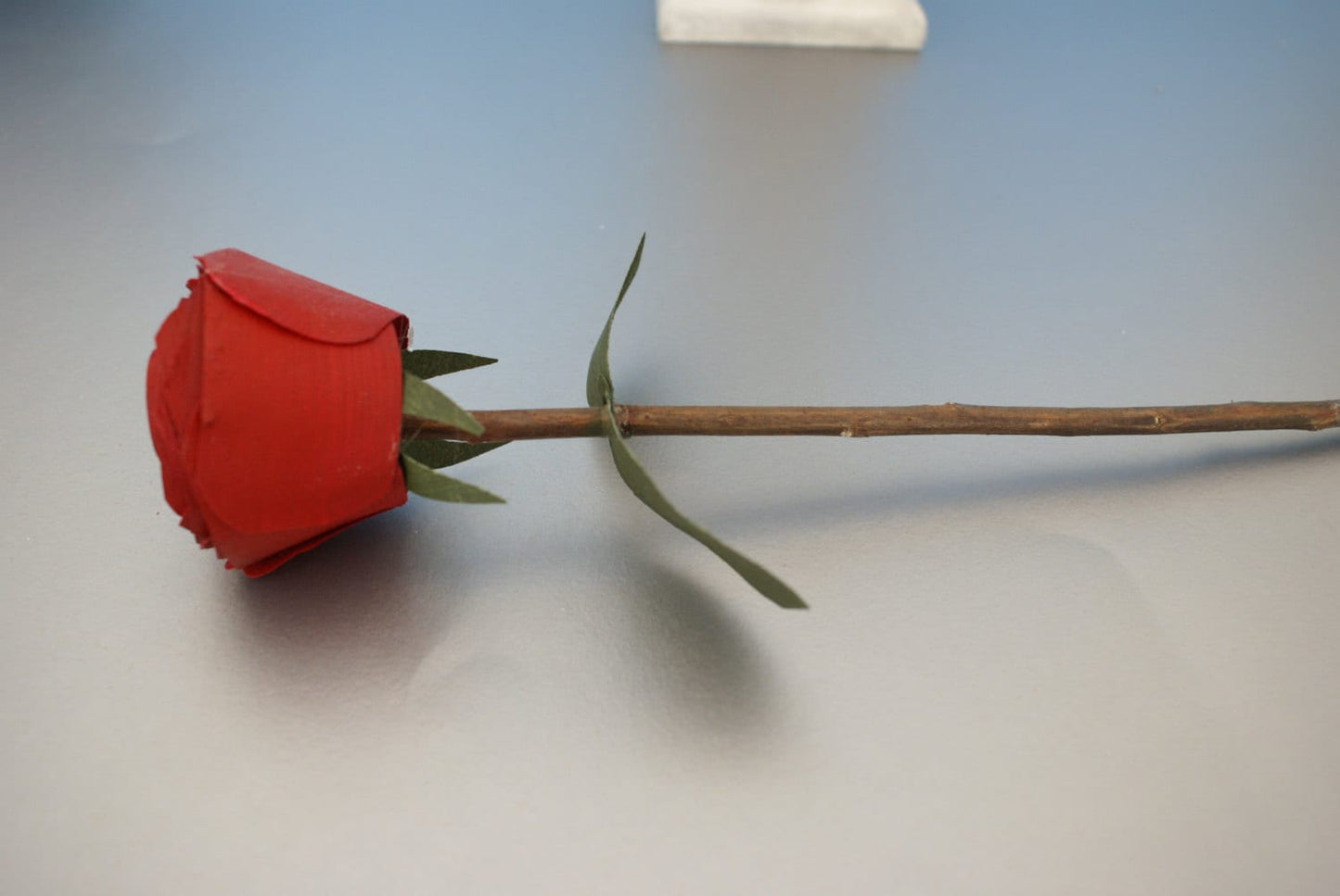 5 Red wood roses on real branch in white wood vase