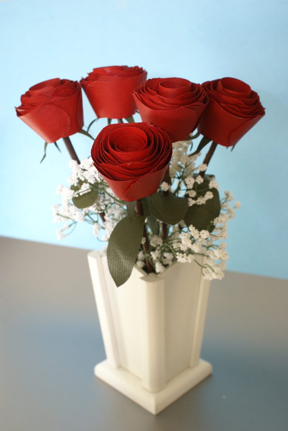 5 Red wood roses on real branch in white wood vase