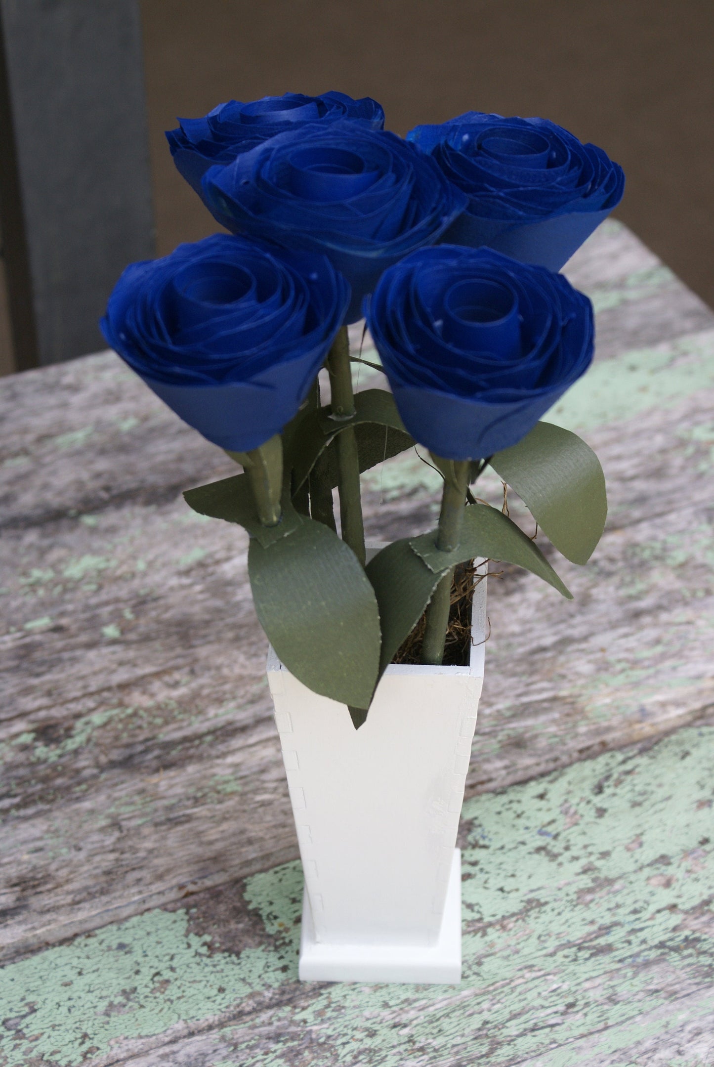 5 Blue wood roses in white vase, blue and white,