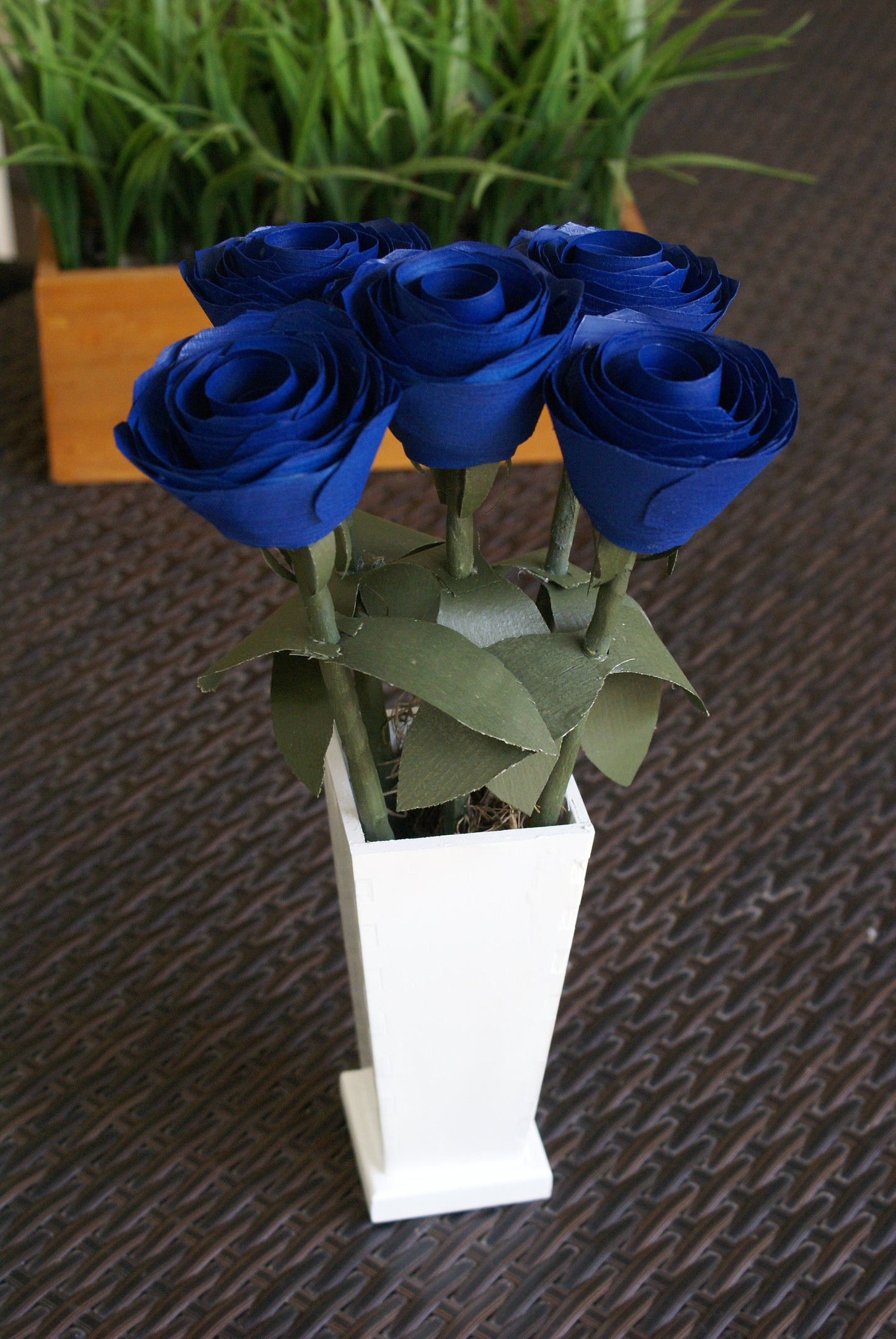 5 Blue wood roses in white vase, blue and white,